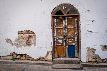 Old door and destroyed wall in a house in Antalya, Turkey.