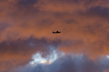 Small plane flying in the morning surise sky