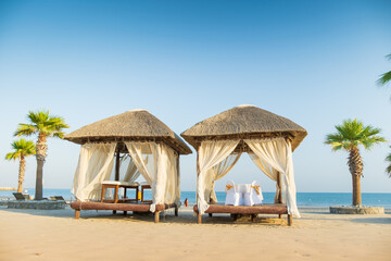two tropical bungalows on the beach with romantic decoration