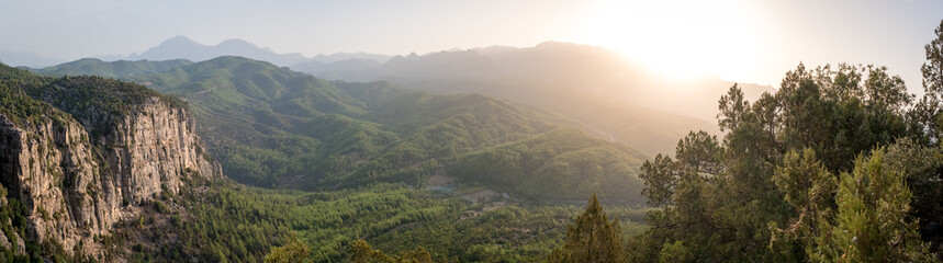 Morning landscape just after sunrise. The sun's rays fall on the mountain valley. Aerial view of Koprulu National Park near ancient city of Selge Adam Kayalar, Turkey. High resolution panorama