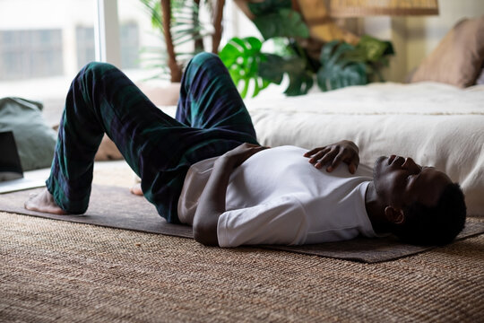 African adult man relax after working out breathing.