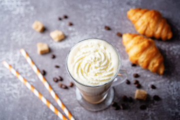 Coffee with whipped cream in a glass with coffee beans