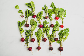 Red bacchus radishes on a white surface