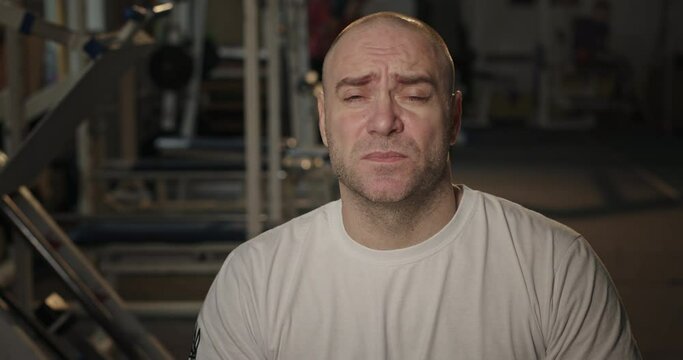 Tired male athlete looking at camera