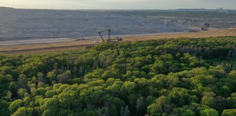 Aerial view of the Hambacher Forest and  in the background the nearby open pit Hambach