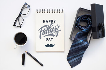 Happy Fathers Day gift box with tie on white background.