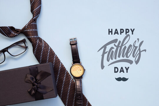 Design concept top view of Father's day gift idea with greeting on blue background.