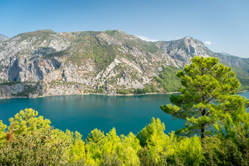 Fototapeta premium Dam lake in Green Canyon. Beatiful View to Taurus Mountains and turquoise water. Coniferous forest with bright green pine trees. Manavgat, Turkey