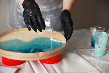 liquid art workshop, epoxy resin is poured on the surface. Master class, hobby.