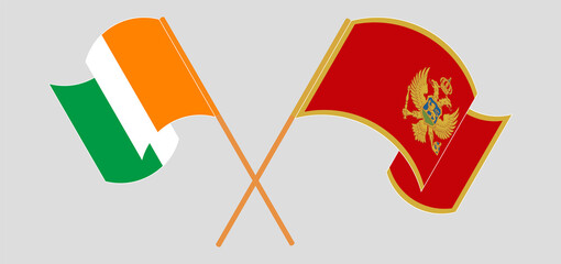 Crossed and waving flags of Republic of Ivory Coast and Montenegro