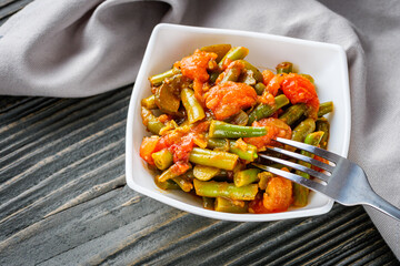 stewed green beans on a dark wooden rustic background
