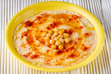 traditional turkish hummus on a white wooden rustic background