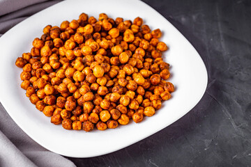 fried chickpeas on a dark stone background