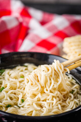 instant egg noodles on a dark stone background