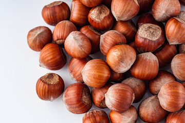 fresh natural hazelnuts on a white acrylic background