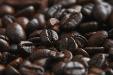 Coffee beans background. Brown roasted coffee beans. Closeup shot of coffee beans.  Fresh roasted coffee beans.