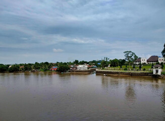 Fototapeta na wymiar View of The Astana and Kuching City from the river. City Waterfront. Borneo Island. Sarawak. Malaysia. South-East Asia