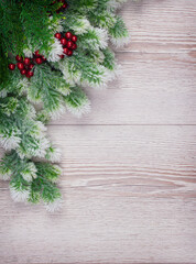 Christmas still life with snowy pine and fir branches on light background. Winter or Christmas festive concept. Top view