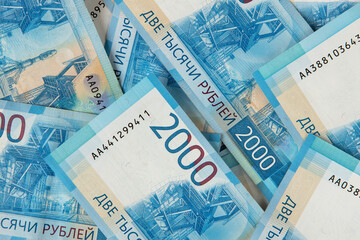 Background from Russian money, many banknotes rubles, denomination 2000, close-up. Concept of cash, salary, loan, wealth, sweet life, credit, finance, business, deposit, insurance. Top view, flat lay