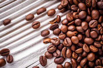 aromatic fresh coffee beans on a white wooden rustic background