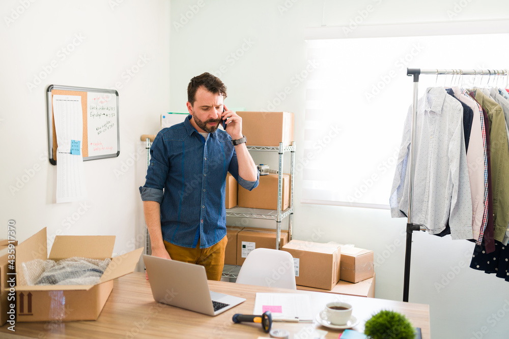 Wall mural Handsome entrepreneur working on the e-commerce business