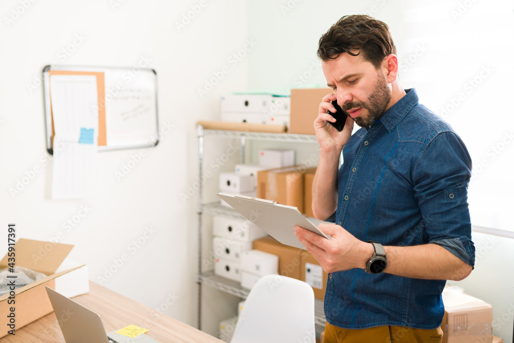 Wall mural Good-looking man speaking to a customer