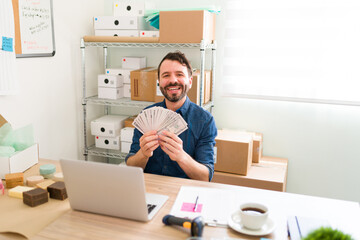 Excited man and business owner holding cash