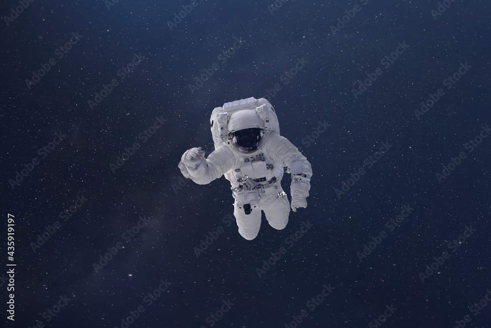 Wall mural cosmonaut fly in the outer space with stars and galaxy background with a light beam. elements of thi