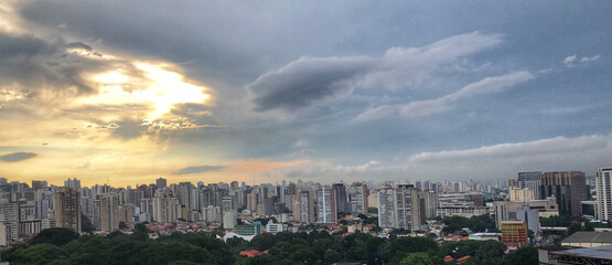 Series São Paulo from my window: a privileged viewpoint. Dramatic storm clouds are arriving, on background the sunset.