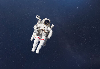 cosmonaut fly in the outer space with stars and galaxy background with a light beam. elements of...