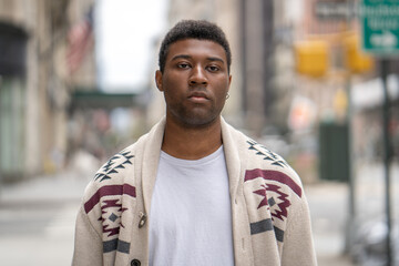 Young black man in city serious face portrait