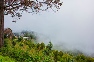 Hills station with fog around the hills and village 