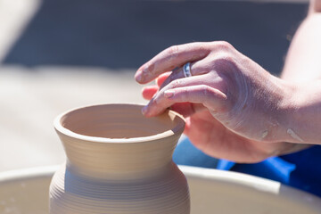 Fototapeta na wymiar Making pots from white clay.