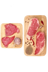 Pepper and Striploin Beef Steaks on Wooden Board Isolated On White Background. Raw Sirloin Beef or Veal Steaks White Isolated, Top View. Tenderloin Beef Steaks On Wood, Overhead View.