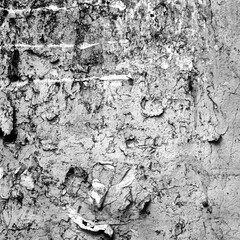 Scratched Advertising On Grunge Wall Background. Exposed Weathered Urban Wall with Torn Street Posters, Paper and Stickers. Old Billboard with Torn Posters. Vintage Frame Background and Texture.