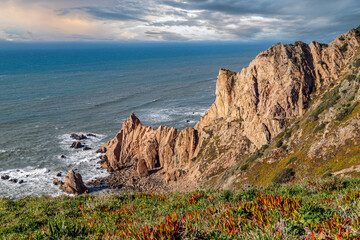 Beautiful Portugal. The rocky coast of Atlantic ocean at sunset in Portugal near Cape Roca. 