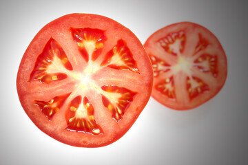 juicy red tomato slice isolated close up of seeds flesh and textures