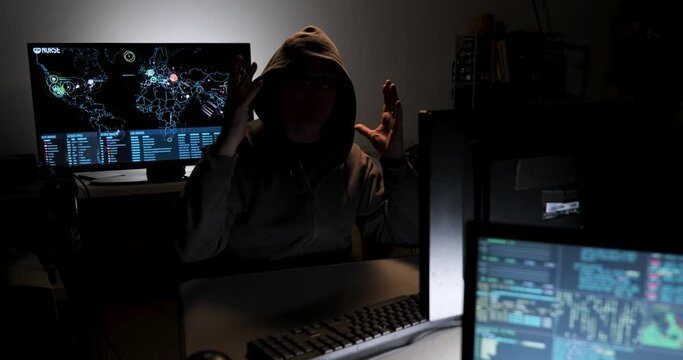 Computer hacker types code attempting to hack a computer server