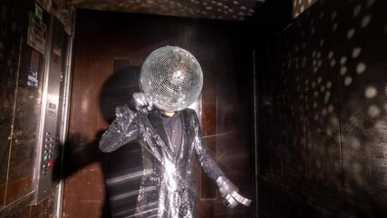 Mr disco ball dancing in a lift