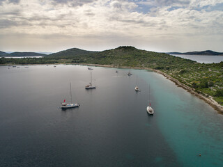 Fototapeta na wymiar Croatian islands and sailing ships from drone view