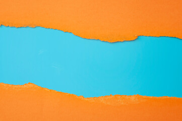 Horizontal border and colorful backgrounds concept with torn orange paper and copy space on blue...