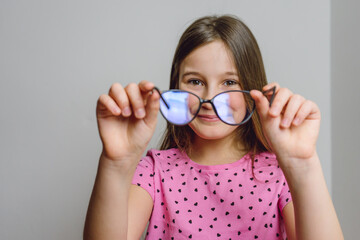 Portrait of a cute beautiful 8 year old girl with glasses