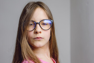 Portrait of a cute beautiful 8 year old girl with glasses