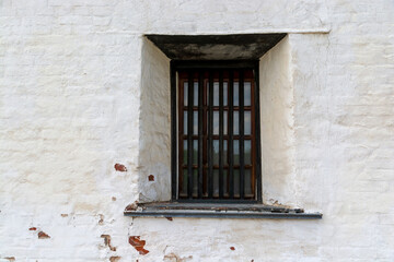 Fototapeta na wymiar window with bars in an old medieval castle.