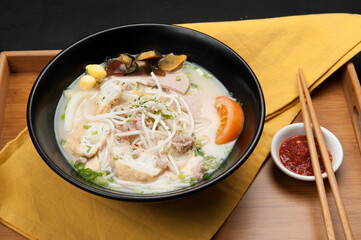 Noodles and tofu in an Asian soup at a Korean restaurant.
