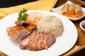Pork belly, brown rice, and spring rolls at a Korean restaurant.