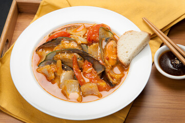 Mussels and red peppers in an Asian soup at a Korean restaurant.