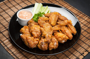 A plate of Asian fried chicken wings at a Korean restaurant.