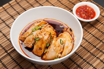 Chicken in an Asian soup at a Korean restaurant.