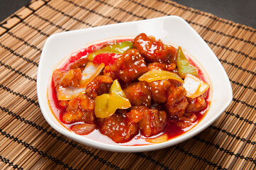 Sweet and Sour pork with yellow and green peppers at a Korean restaurant.